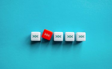 Row of five white dice with DNA symbols with one red die tilted at an angle, symbolising genetic variation or mutation, on a blue background.