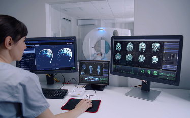 Medical imaging control room with monitors displaying scans and a scanner in the background, illustrating radiopharmaceutical use