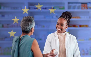 Healthcare professional speaking with a patient in front of medicine shelves, with EU symbols in the background