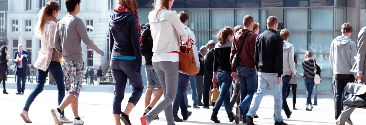 Crowd of people walking in a public square