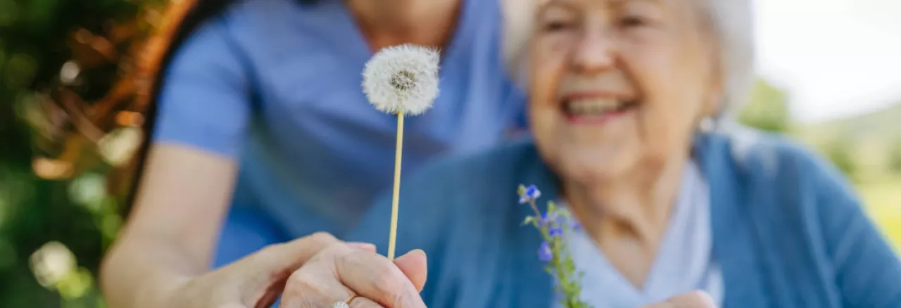 Old lady holding a flower