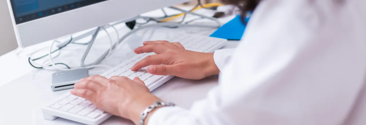 Person typing on computer keyboard