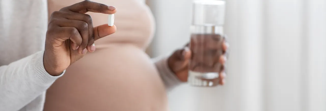 Pregnant woman and a pill