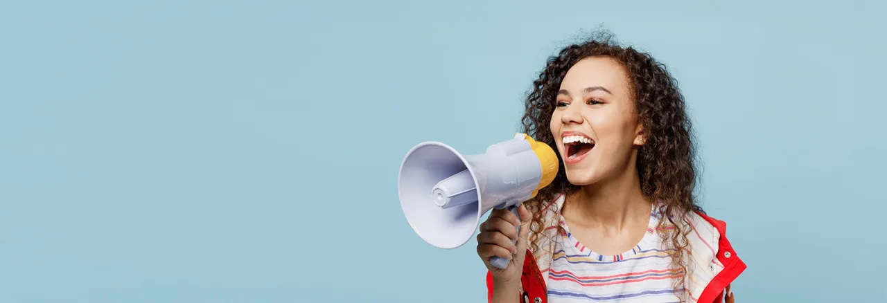 Person speaking into a megaphone to promote a campaign