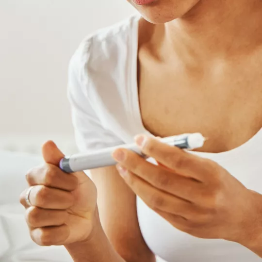 close up of a woman holding a medical device