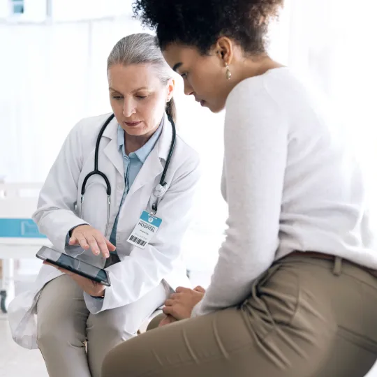 A doctor and a patient looking at a screen