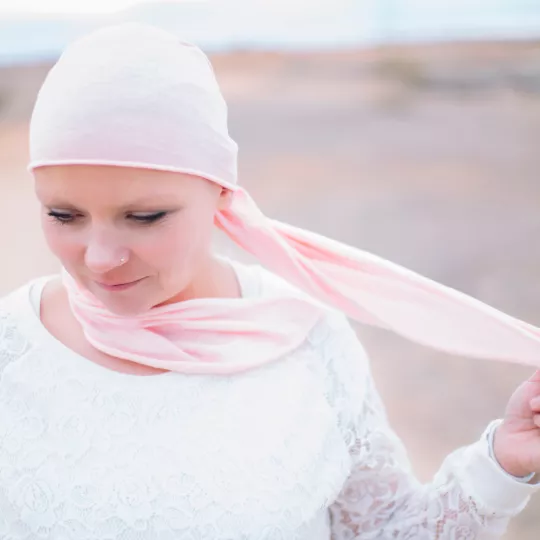 Woman wearing a headscarf while standing in a field