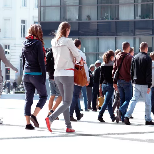 Crowd of people walking in a public square