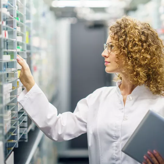 Pharmacist looking at medicines