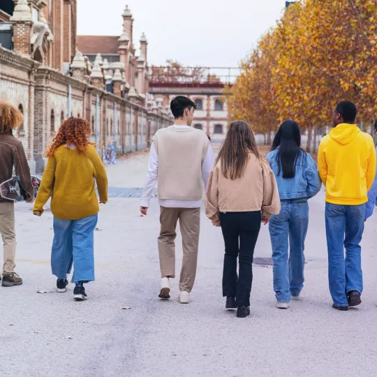 A group of people walking on a street