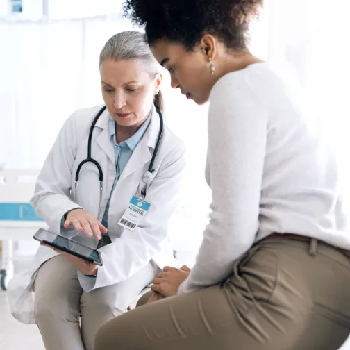 A doctor and a patient looking at a screen