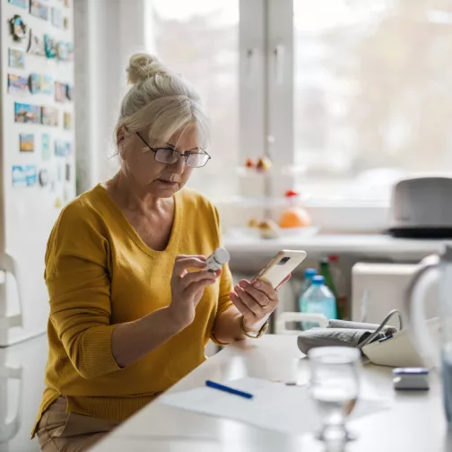 Women looking at a pill package