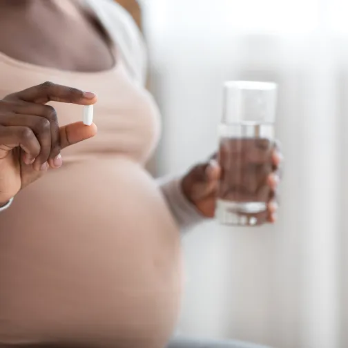 Pregnant woman and a pill